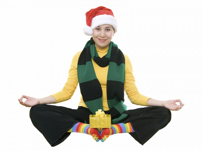 Happy woman wearing holiday clothes doing yoga